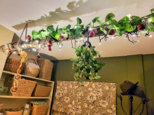 A fallen branch suspended from the ceiling as a festive Christmas decoration with added (fake) mistletoe.