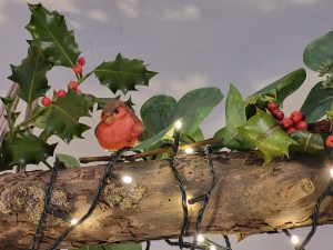 Ceramic robin on a yule log