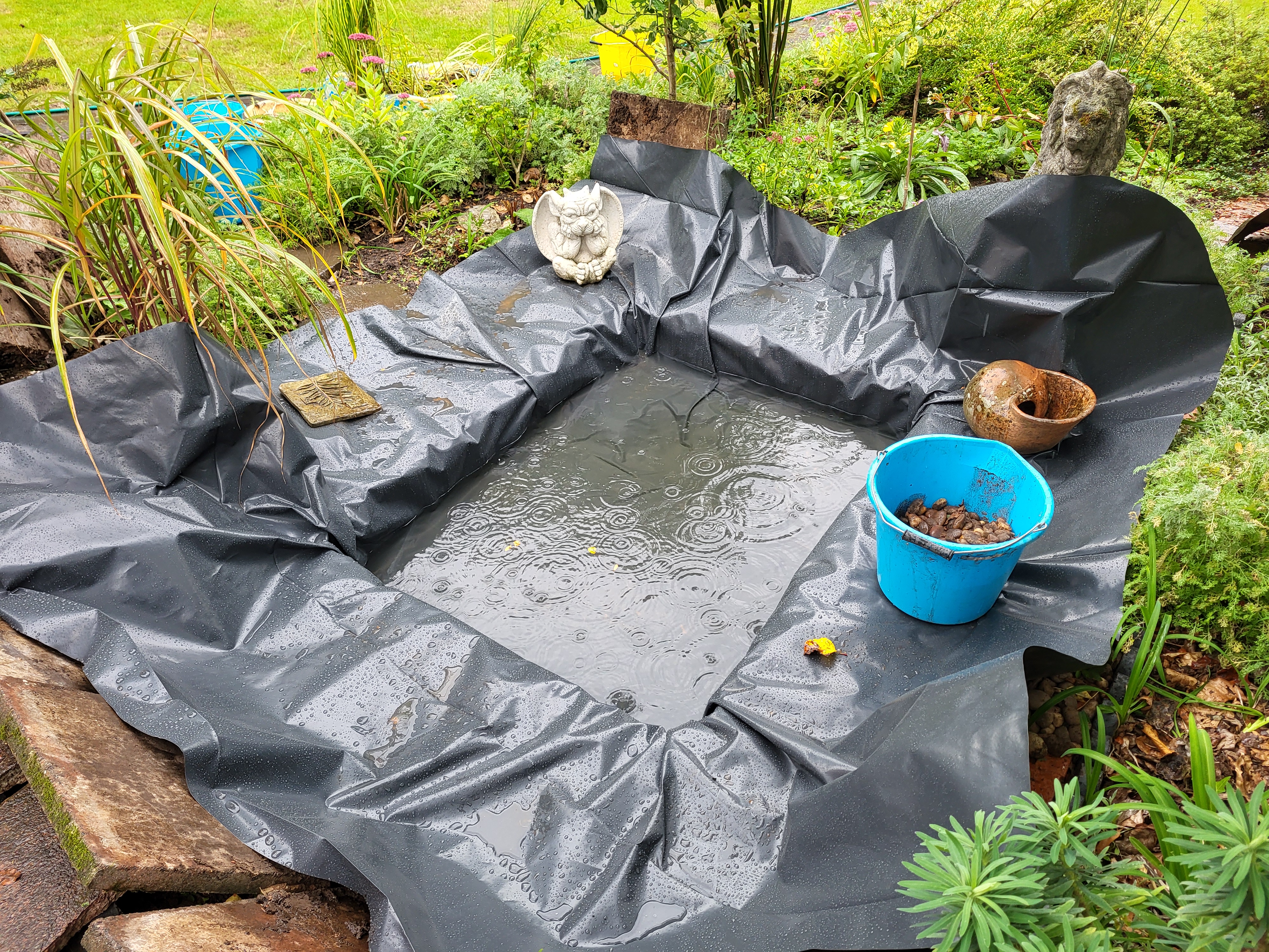 Liner installed and the rain helps to refill Lion Pond.